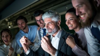 A Group Of Business People With Computer In An Office Expressing Excitement