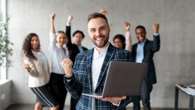 Joyful Businessman And His Team Celebrating Business Success In Office