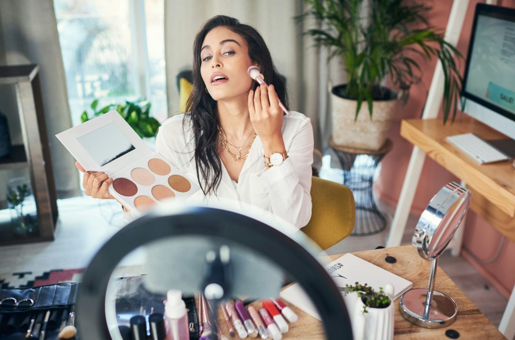 Shot of a influencer recording a makeup tutorial for her blog at home